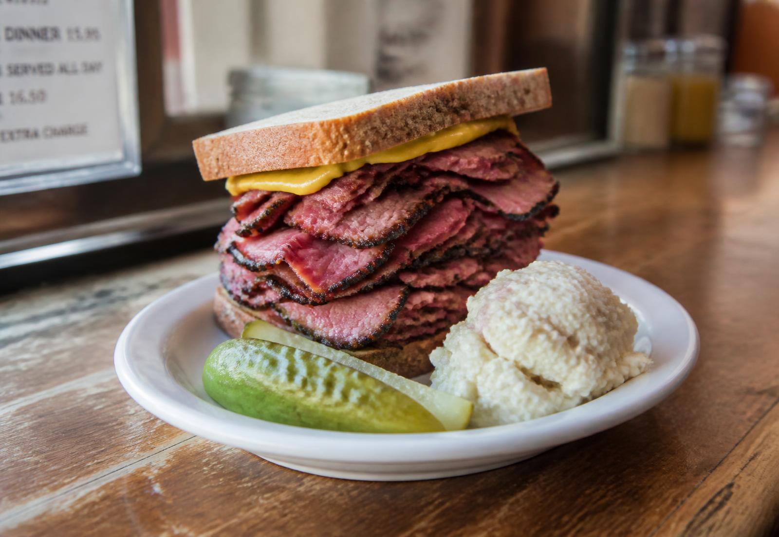 Hot pastrami piled high on rye with a kosher pickle spear
